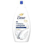 A 450ml bottle of Dove Indulging Caring Bath Moisturising Cream, designed for soft and smooth skin, with a white and blue label.